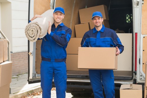 Packed moving boxes and wrapped furniture ready for a Chelsea relocation