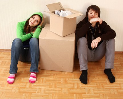 Professional movers unloading boxes into a new Chelsea home