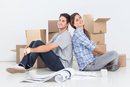 Movers handling desks and office furniture in a Chelsea building
