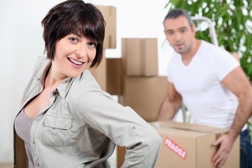 Packed boxes and household items being arranged in a removal van